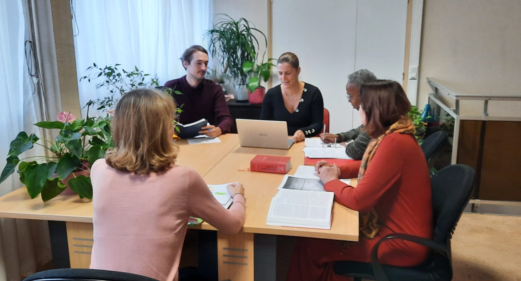 5 bénévoles ADEIC en réunion autour d'une table