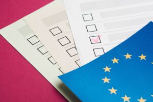 trois feuilles de papier avec des cases à cocher, recouvertes par un drapeau de l'europe