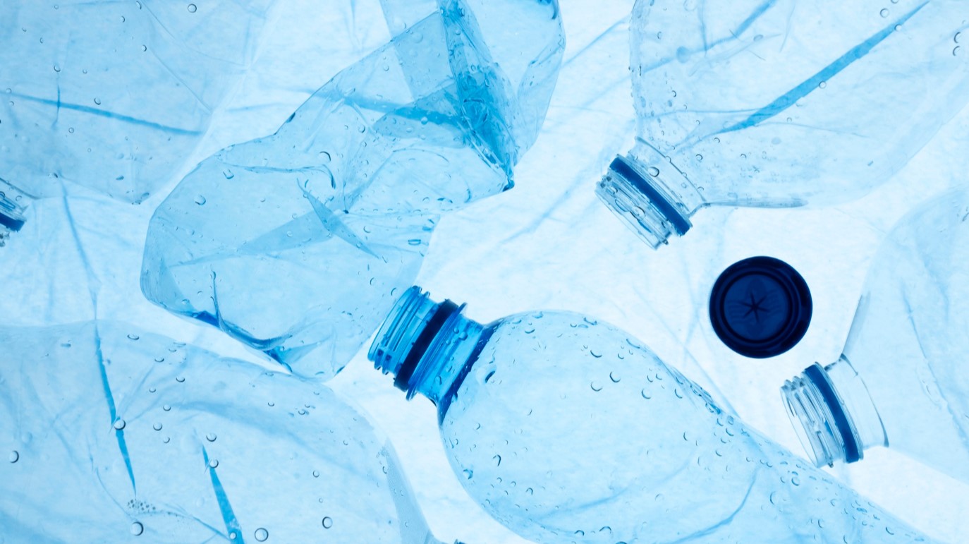 amoncellement de bouteilles en plastiques vides avec un bouchon